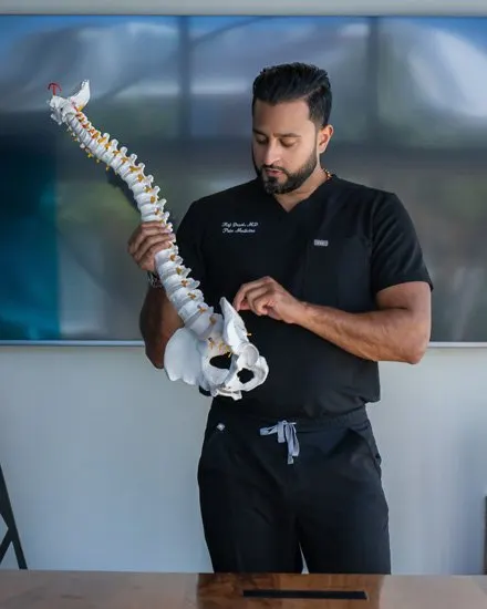 Dr. Raj Desai explaining the spine using an anatomical spine model